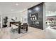 Open-concept dining area featuring a modern fireplace and seamless flow into other living spaces at 4 Meadowlark Ln, Littleton, CO 80123