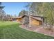 Inviting single-story home showcasing a lush green lawn and charming landscaping, perfect for outdoor enjoyment at 4 Meadowlark Ln, Littleton, CO 80123
