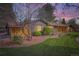 Charming single-story home featuring a well-manicured lawn, mature trees, and unique rock landscaping at 4 Meadowlark Ln, Littleton, CO 80123