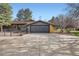 Spacious home exterior featuring a large garage and well-maintained landscaping at 4 Meadowlark Ln, Littleton, CO 80123
