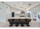 Bright, open kitchen featuring an island with bar seating, stainless steel appliances, and modern pendant lighting at 4 Meadowlark Ln, Littleton, CO 80123