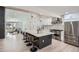 Bright, open kitchen featuring an island with bar seating, stainless steel appliances, and modern pendant lighting at 4 Meadowlark Ln, Littleton, CO 80123