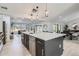 Bright, open kitchen featuring an island with bar seating, stainless steel appliances, and modern pendant lighting at 4 Meadowlark Ln, Littleton, CO 80123