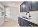Beautiful laundry room with sink, modern cabinets with gold handles, and natural light at 4 Meadowlark Ln, Littleton, CO 80123