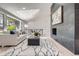 Open-concept living area features a statement fireplace, vaulted ceilings, and a view of the outdoors at 4 Meadowlark Ln, Littleton, CO 80123