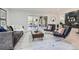 Modern living room with stylish furniture, a sliding glass door to the backyard, and hardwood floors at 4 Meadowlark Ln, Littleton, CO 80123