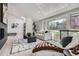 Bright living room with vaulted ceilings, a cozy chaise lounge, and large windows offering scenic views at 4 Meadowlark Ln, Littleton, CO 80123
