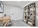 Bright office space features a classic desk, plenty of shelving, and neutral carpet at 4 Meadowlark Ln, Littleton, CO 80123