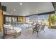 Relaxing covered patio with lounge seating, dining area, and outdoor movie theater at 4 Meadowlark Ln, Littleton, CO 80123