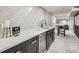 Modern wet bar features black cabinetry, a wine fridge, and striking white textured backsplash at 4 Meadowlark Ln, Littleton, CO 80123