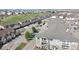 Aerial view of the exterior of the condo building with balconies and the surrounding neighborhood and a golf course at 1574 Olympia Cir # 305, Castle Rock, CO 80104