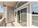 Balcony with railing, grey siding, door to storage, and large sliding glass door to the house at 1574 Olympia Cir # 305, Castle Rock, CO 80104