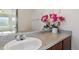 A well-lit bathroom features a vanity with a granite countertop and a large mirror at 1574 Olympia Cir # 305, Castle Rock, CO 80104