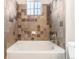 The bright bathroom includes a shower-tub combo with eye-catching tile, offering a refreshing experience at 1574 Olympia Cir # 305, Castle Rock, CO 80104