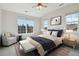 This bedroom features large windows, a comfortable seating area, and a modern king-size bed at 1574 Olympia Cir # 305, Castle Rock, CO 80104