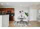 A charming dining area features a white table, plush chairs, and stylish decor for elegant meals at 1574 Olympia Cir # 305, Castle Rock, CO 80104
