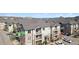 Exterior view of the condo building with stone and siding, balconies, and visible parking area at 1574 Olympia Cir # 305, Castle Rock, CO 80104