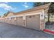Exterior view of multiple condo garages with stone accents on the garages at 1574 Olympia Cir # 305, Castle Rock, CO 80104