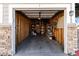 Interior view of a garage with stone accents and ample space for storage at 1574 Olympia Cir # 305, Castle Rock, CO 80104