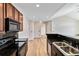 Kitchen view from the sink shows stainless steel appliances and dark countertops, next to the entryway hall at 1574 Olympia Cir # 305, Castle Rock, CO 80104
