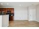 An open-concept living space boasts wood floors and a modern kitchen with stainless steel appliances at 1574 Olympia Cir # 305, Castle Rock, CO 80104