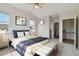 This staged main bedroom boasts a closet, ensuite bathroom, and windows with views at 1574 Olympia Cir # 305, Castle Rock, CO 80104