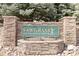 Stone monument sign for Sawgrass at Plum Creek with trees in background at 1574 Olympia Cir # 305, Castle Rock, CO 80104