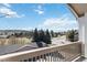 Balcony view featuring a neighborhood street with trees and a distant hillside at 1574 Olympia Cir # 305, Castle Rock, CO 80104