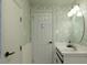 Bathroom featuring floral wallpaper, a sink with a vanity, and white doors at 3410 W 31St Ave, Denver, CO 80211