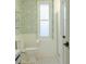 Bright bathroom with white subway tile, floral wallpaper, and glass shower at 3410 W 31St Ave, Denver, CO 80211