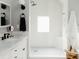 Bright bathroom features tile shower with glass door, neutral walls and vanity with sink at 3410 W 31St Ave, Denver, CO 80211