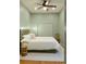 Cozy bedroom with a platform bed, natural lighting, and wooden stool next to the bed at 3410 W 31St Ave, Denver, CO 80211