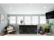 A bright bedroom featuring neutral walls, many windows, and black dresser at 3410 W 31St Ave, Denver, CO 80211