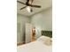 Comfortable bedroom with a plush green headboard, access to an ensuite bathroom and views to the dining room at 3410 W 31St Ave, Denver, CO 80211