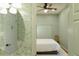 Cozy bedroom featuring floral wallpaper, ceiling fan, and a comfortable bed at 3410 W 31St Ave, Denver, CO 80211