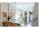 Bright kitchen showcasing a breakfast bar, open shelving, and modern lighting at 3410 W 31St Ave, Denver, CO 80211