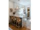 Bright kitchen showcasing a breakfast bar, open shelving, and modern lighting at 3410 W 31St Ave, Denver, CO 80211