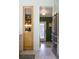 Bright kitchen featuring a glass-door pantry with decorative items and stainless steel refrigerator at 3410 W 31St Ave, Denver, CO 80211