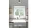 Farmhouse sink with modern faucet and a view to the lush green backyard at 3410 W 31St Ave, Denver, CO 80211