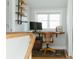 Functional home office area, with a unique wooden desk, a chair, and natural light at 3410 W 31St Ave, Denver, CO 80211
