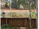 Backyard view with a wooden fence and deer grazing in the native grasses beyond the yard at 10535 Cottoneaster Way, Parker, CO 80134