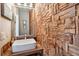 Unique powder room with square sink, wood wall and a rustic wood counter at 10535 Cottoneaster Way, Parker, CO 80134