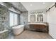 Luxurious bathroom showcasing a freestanding tub, double vanity, and modern fixtures at 10535 Cottoneaster Way, Parker, CO 80134