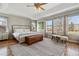 Light-filled bedroom with hardwood floors, large windows, and neutral decor at 10535 Cottoneaster Way, Parker, CO 80134