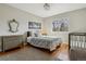 Comfortable bedroom with hardwood floors, a gray rug, and soft natural lighting at 10535 Cottoneaster Way, Parker, CO 80134