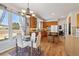 Sunlit kitchen dining area with a chandelier and hardwood floors at 10535 Cottoneaster Way, Parker, CO 80134