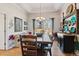 Bright dining area with a large wooden table, stylish chairs, and plenty of natural light at 10535 Cottoneaster Way, Parker, CO 80134