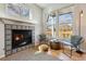 Inviting fireplace with decorative tiles, a window, and natural light at 10535 Cottoneaster Way, Parker, CO 80134