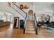 Elegant foyer with a staircase, hardwood floors, and views into the living and dining spaces at 10535 Cottoneaster Way, Parker, CO 80134