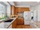 Bright kitchen with granite countertops, stainless steel appliances, and wood cabinets at 10535 Cottoneaster Way, Parker, CO 80134